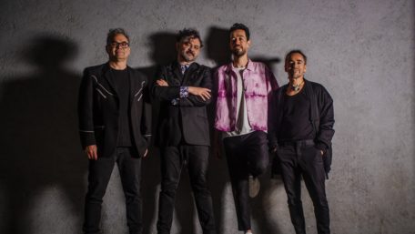 Cafe-Tacvba-in-front-of-gray-wall-all-band-members